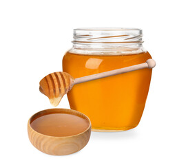 Natural honey dripping from dipper into wooden bowl. Jar full of honey on white background