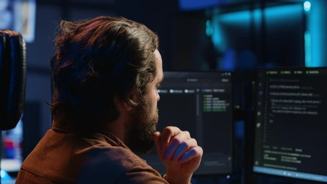 Software engineer puzzled in front of computer screen while writing complex code. Admin feeling confused while trying to fix database errors while working from home, camera A close up