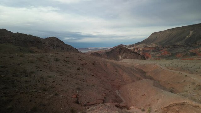 Aerial above dirt road in Kingman Wash Arizona desert by lake Mead