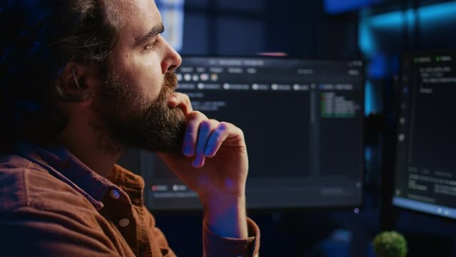 Software engineer puzzled in front of computer screen while writing complex code. Admin feeling confused while trying to fix database errors while working from home, camera B close up