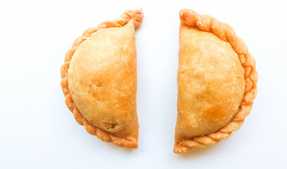 Curry puff and Fried Pastel or fried dry pastry filled with stir-fried vegetables, chicken and boiled eggs isolated on a white background