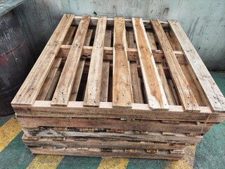 Stack of wooden pallet. Industrial wood pallet at factory warehouse. Cargo and shipping concept. Sustainability of supply chains. Eco-friendly nature and sustainable properties.