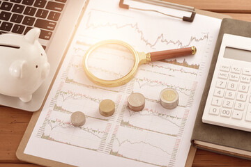 On the stock market chart are various office supplies used for research and investment.The meaning...
