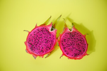 Fresh red dragon fruit or pitaya ready to eat on yellow background, tropical fruit 