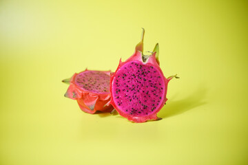 Fresh red dragon fruit or pitaya ready to eat on yellow background, tropical fruit 