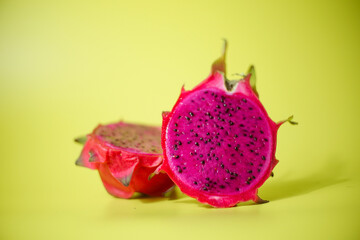 Fresh red dragon fruit or pitaya ready to eat on yellow background, tropical fruit 