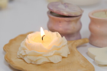 The lighter ignites a candle, light a candle Christmas home decoration and aromatherapy concept in...