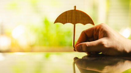 Hand of man holding an umbrella symbol. Insurance concept, Family life insurance and policy...