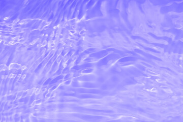 Water surface. Purple water waves on the surface ripples blurred. Transparent pink colored clear calm water surface texture with splash and bubbles. Purple water waves with shining patterns. Caustics.