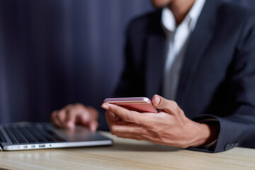 Businessman holding smartphone working in office and photocopying area, business success concept.