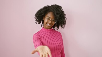 Cheerful african american woman in glasses offering a friendly help hand, symbol of acceptance - a beautiful black female offering assistance, standing with charming smile indoors.