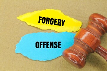 colored paper with the word forgery offence. concept of legal offense