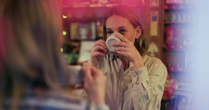Women, friends and talk in coffee shop, drink and happy for reunion, date and conversation on break. Girl, people and smile for chat, memory and relax with tea cup, latte or espresso in cafe together
