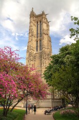 historical Flamboyant Gothic tower with blue sky as background