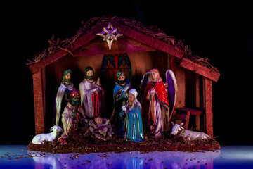 Holy family. Christmas creche with Joseph Mary and Jesus. Christmas Manger scene with figurines...