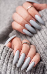 Woman's hand with grey nail polish