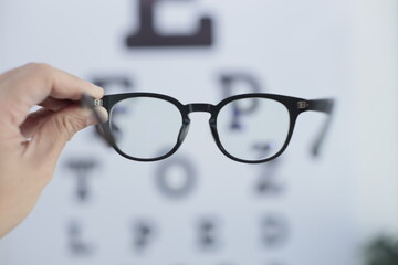 Hand holding glasses in optical store 