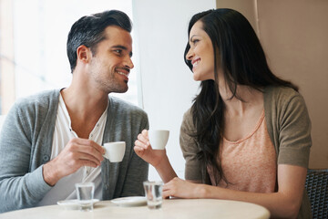 Date, coffee and couple at cafe with relax, smile and together with love and hot drink at a table....