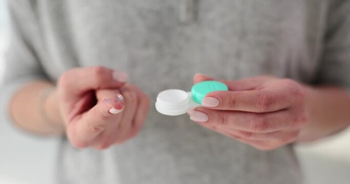 Soft contact lenses and a plastic case in female hands