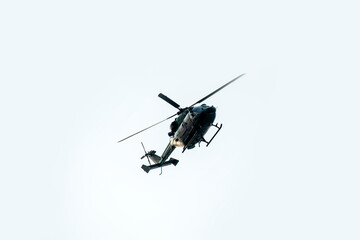 helicopter is flying on isolated blue sky.