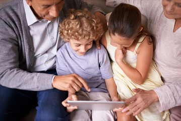 Family, children and grandparents pointing with tablet for entertainment or social media on sofa at...