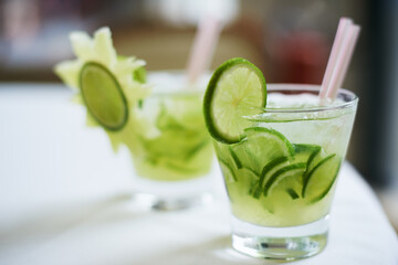 Cocktail, alcohol and glass with fruit for mojito drink on table for party, club and bar. Mockup,...