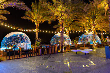 Transparent domed gazebo in the style of an igloo for romantic dates of lovers. Night view. Open...