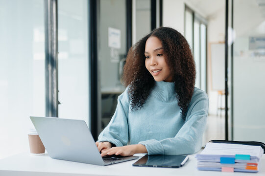 Portrait of female office businesswoman startup daydreaming about her work, startup and working with laptop on office