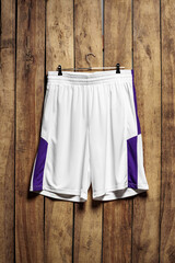 Basketball shorts hanging against wooden background