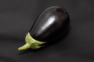 ripe eggplants on a black background