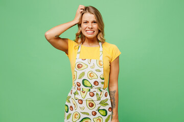 Young puzzled sad displeased housewife housekeeper chef cook baker woman wear apron yellow t-shirt...