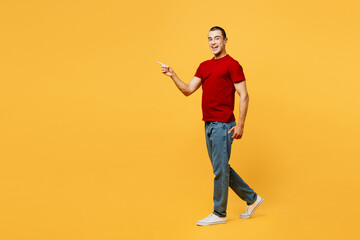 Full body side profile view smiling happy cheerful young middle eastern man he wear red t-shirt...