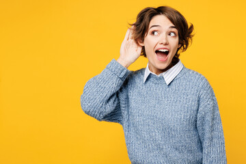 Young curious nosy fun woman she wearing grey knitted sweater shirt casual clothes try to hear you...