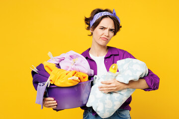 Young dissatisfied upset sad happy woman wear purple shirt do housework tidy up holding look at...