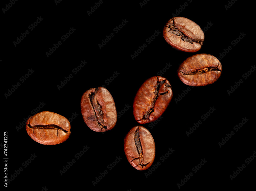 Wall mural Coffee beans isolated on black background. Close-up