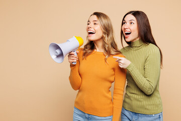 Side view young friends two women wear orange green shirt casual clothes together hold in hand...