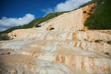 Narzan mineral spring in Georgia. Yellow mineral deposits on the surface of the earth. The healing waters of the planet