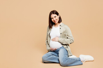 Full body smiling happy young pregnant woman future mom she wear grey shirt with belly stomach...