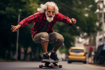 Foto auf Acrylglas an elderly man taking advantage of life going down a city street at full speed on a skateboard © Rojo