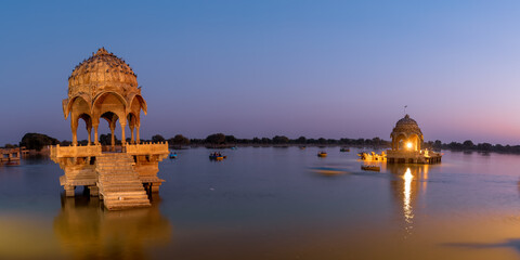 Historic Chhatri, an elevated dome pavilions in Gadisar lake, Rajasthan, India shot during twilight.
