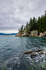rugged coastline of West Vancouver, BC with Bowen Island in the distance across Howe Sound