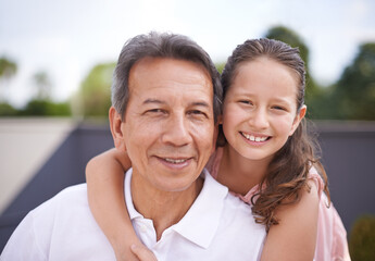 Obraz premium Outdoor, portrait and girl hug grandpa on summer, holiday or vacation together in retirement with love. Senior, man and grandparent relax with child in backyard, garden or embrace in Mexico with care