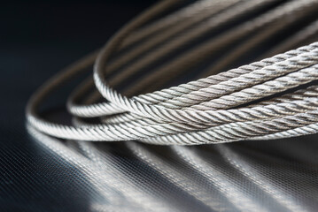 Steel wire rope cable on metal surface - obrazy, fototapety, plakaty
