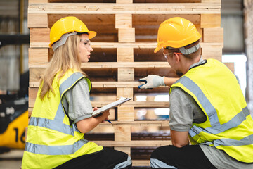 Engineer team standing walking in warehouse examining hardwood material for wood furniture...