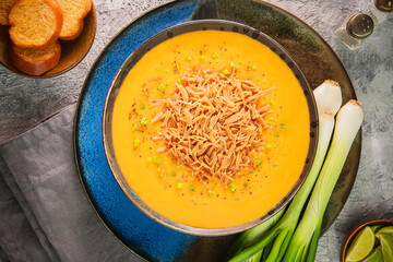 Arabic Cuisine; Middle Eastern velvety traditional red lentil soup. Topped with golden fried vermicelli. Served with crispy croutons, green onion and fresh lemon.