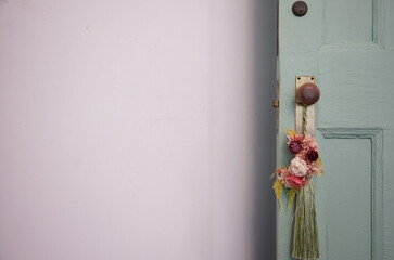 Flowers decorated on the wooden door and doorknob at the entrance of the room