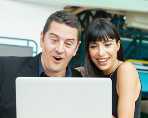 caucasian man and black woman happy talking with friend on laptop. businessman and businesswoman meeting with colleague in relaxing workplace. businessman and businesswoman working in modern office