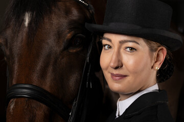 Dressage rider head portraits, with top hat next to her horse.