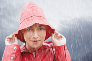 Woman, smile and portrait with rain, coat and clouds with happiness in nature. Person, face and...