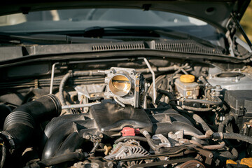 Electronic throttle body and engine bay background. Service and repair.